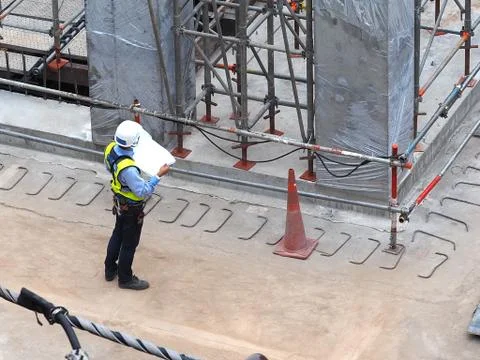 Engineer checking drawing of new buuilding in construction plant Stock Photos
