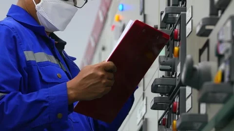 Engineer Checking Electrical Cabinets in Industrial Plant Stock Footage 246437608