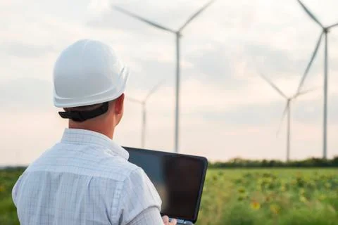 Engineer is checking energy production on wind turbine. Worker in windmills p Stock Photos