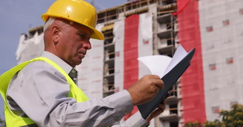 Engineer Checking Folder Files Documents in a Construction Building Site Area Vidéo 66906019