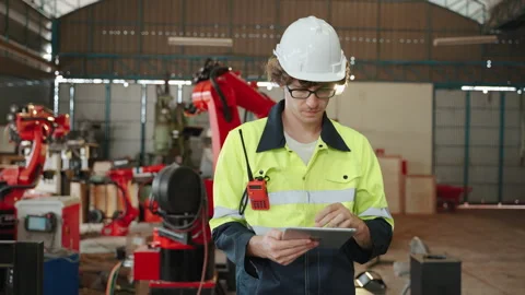 Engineer is checking the list to inspect the factory machinery Stock Footage 255811471