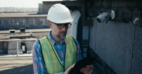 Engineer checking security camera using tablet Stock Footage 126981682