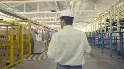 Engineer is checking settings of CNC machine Stock Footage 65456427