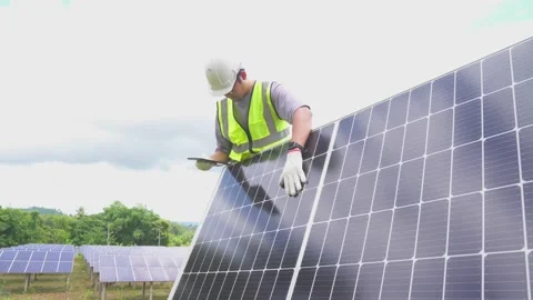 A engineer checking with a tablet the field of photovoltaic solar panels. Stock Footage 210818236