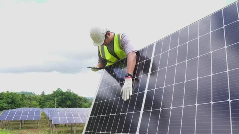 Engineer checking with a tablet the field of photovoltaic solar panels. Stock Footage 210818531