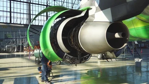 Engineer checks the aircraft engine. Aircraft repair in the hangar.  Stock Footage 84454340