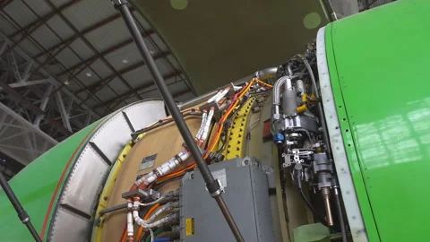 Engineer checks the aircraft engine. Aircraft repair in the hangar.  Stock Footage 95609567