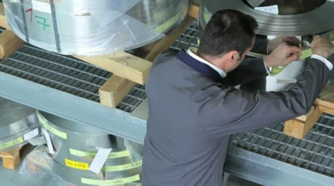 Engineer checks arrival of stripped steel coils Video stock 11899570