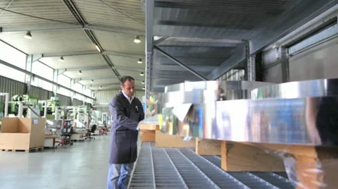 Engineer checks arrival of stripped steel coils Stock Footage 11899619