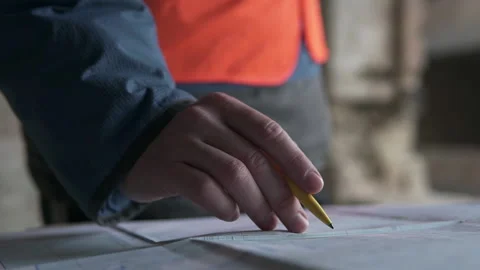 An engineer checks drawings at a high-rise building site. Stock Footage 143309475