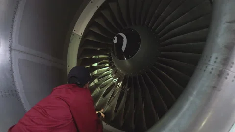 Engineer checks the engine of the aircraft. The repair of aircraft in the hangar Stock Footage 98003659