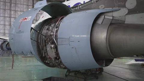 Engineer checks the engine of the aircraft. The repair of aircraft in the hangar Stock Footage 98004754