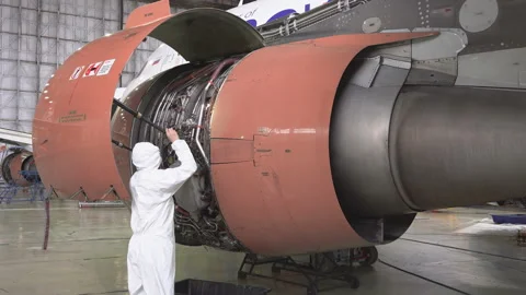 Engineer checks the engine of the aircraft. The repair of aircraft in the hangar Stock Footage 98005095