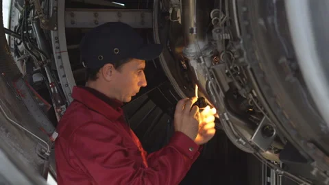 Engineer checks the engine of the aircraft. The repair of aircraft in the hangar Видео 98006449