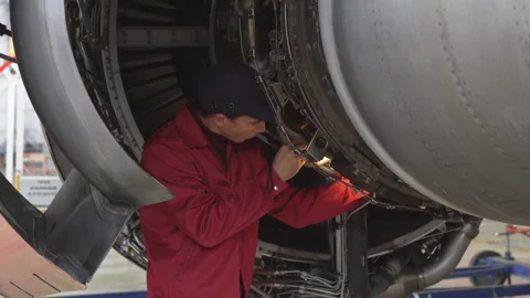 Engineer checks the engine of the aircraft. The repair of aircraft in the hangar Stock Footage 98006769