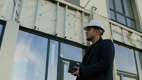 Engineer checks information on a tablet at a modern construction site Foto stock