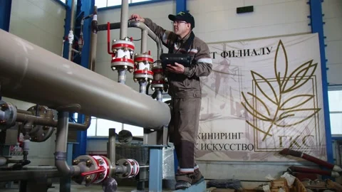 Engineer checks pipeline system element with meter in shop Stock-Footage 136966635
