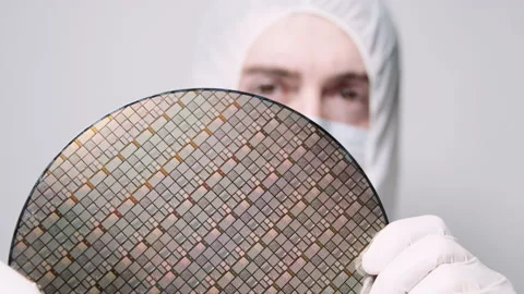 Engineer in Cleanroom suit holds CPU processor hand. Chip Fabrication laboratory Stock Footage 157160412
