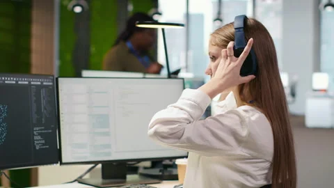 Engineer coding with AI language model assistance in office, listening music Vidéo 313015112