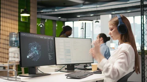 Engineer coding with AI language model assistance in office, listening music Vidéo 313165526