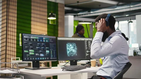 Engineer coding with AI language model assistance in office, listening music Vidéo 313165765