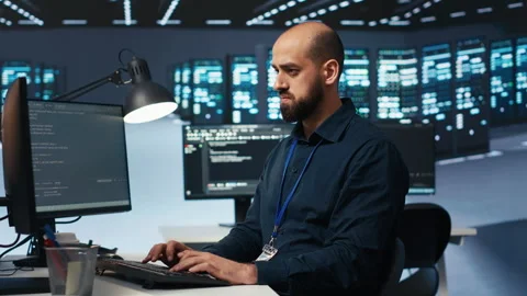 Engineer coding, working in data center facility hosting supercomputers Video stock 275489749