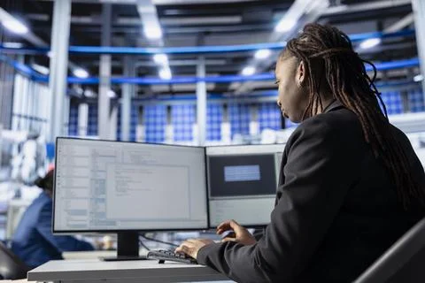 Engineer coding at workstation in solar panel manufacturing plant Stock Photos