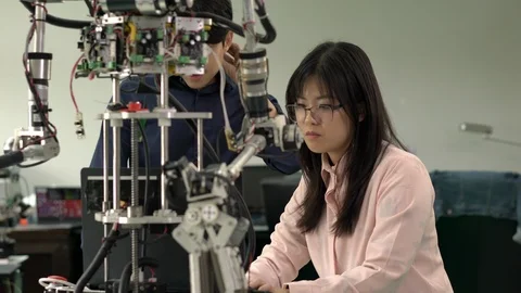 Engineer collaborating development robot in modern laboratory. Stock Footage 113699827