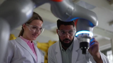 Engineer colleagues working on robotic knee replacement surgery project Stock Footage 277210458