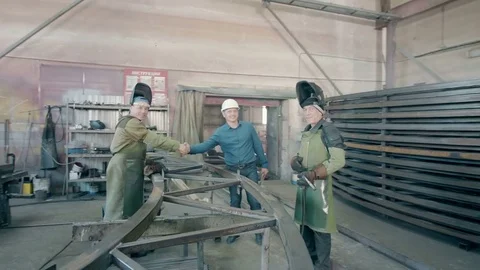 Engineer comes to the production and welcomes workers Видео 80362263