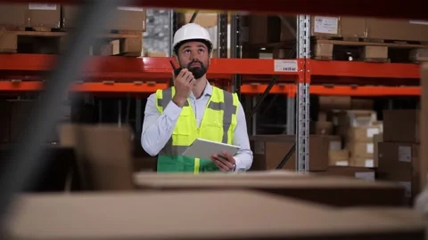 Engineer communicating by radio set in warehouse Video stock 161954807