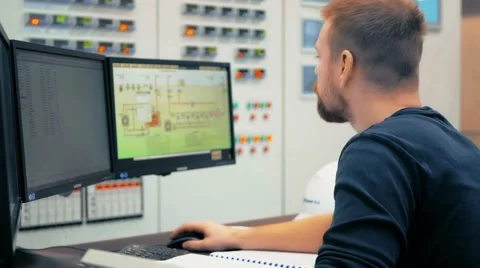 Engineer computer controls the operation of machinery in the modern factory Stock Footage 61314494