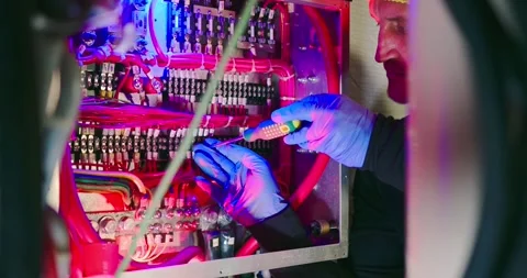 Engineer Conducts Electrical Inspection in Engine Room 스톡 동영상 323747936