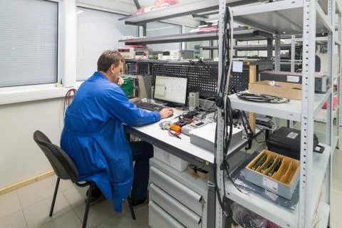 The engineer conducts a test of the finished electronic modules. Laboratory for Stock Photos