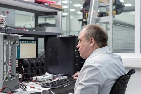 The engineer conducts a test of the finished electronic modules. Laboratory for Stock Photos