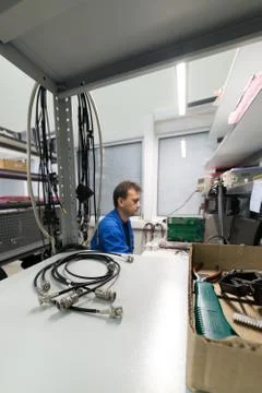 The engineer conducts a test of the finished electronic modules. Laboratory for Stock Photos
