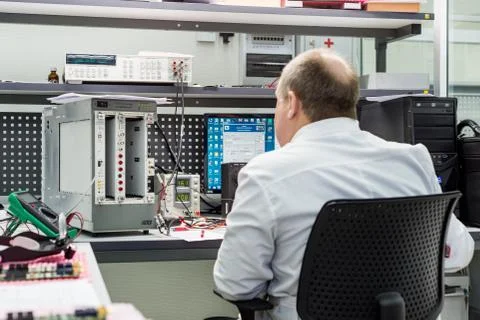 The engineer conducts a test of the finished electronic modules. Laboratory for Foto stock