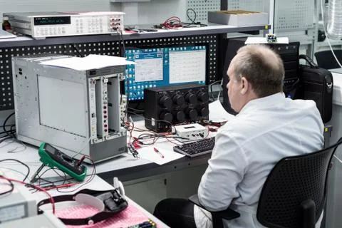 The engineer conducts a test of the finished electronic modules. Laboratory for Foto stock