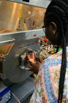 An engineer conducts testing of the Molten Regolith Electrolysis (MRE) insi.. 스톡 사진