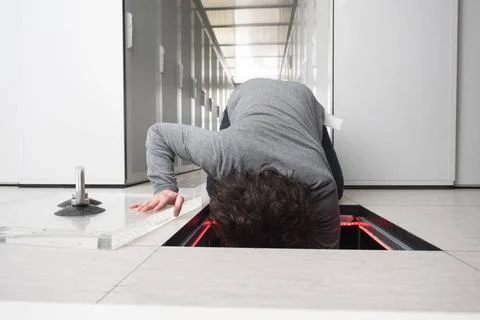 Engineer connecting cables in server room young IT engineer connecting cab... Stock Photos