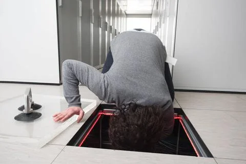 Engineer connecting cables in server room young IT engineer connecting cab... 写真素材