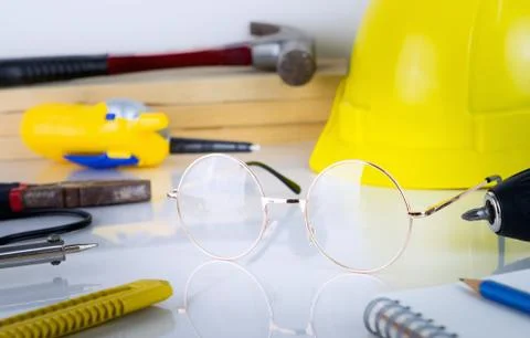 Engineer construction repair tools with eyeglass in the middle Stock Photos