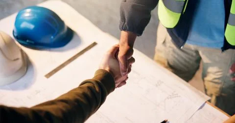 Engineer, construction site and handshake for development agreement, project Stock Photos