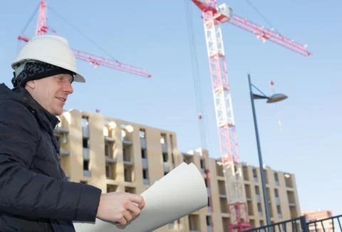 An engineer on a construction site with cranes Stock Photos
