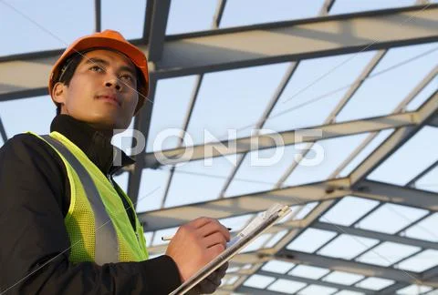 Engineer construction under new building checking plan Stock Photos