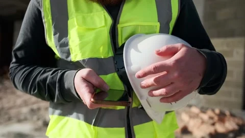 Engineer construction worker scrolls screen with building plans in phone Stock Footage 274479251