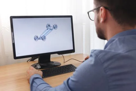 Engineer, Constructor, Designer in Glasses Working on a Personal Computer. He Stock Photos