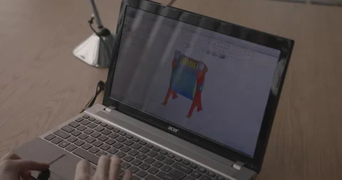 Engineer constructs 3d-model in drawing program on laptop Stock Footage 150999696