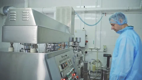 Engineer control pharmaceutical manufacturing. Factory worker operating Stock Footage 114922126