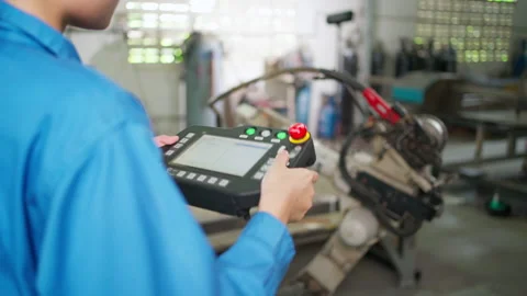 Engineer control robot by using remote control Stock Footage 152981876